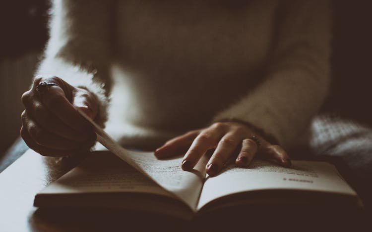 Photo Of Person Flipping Book Page