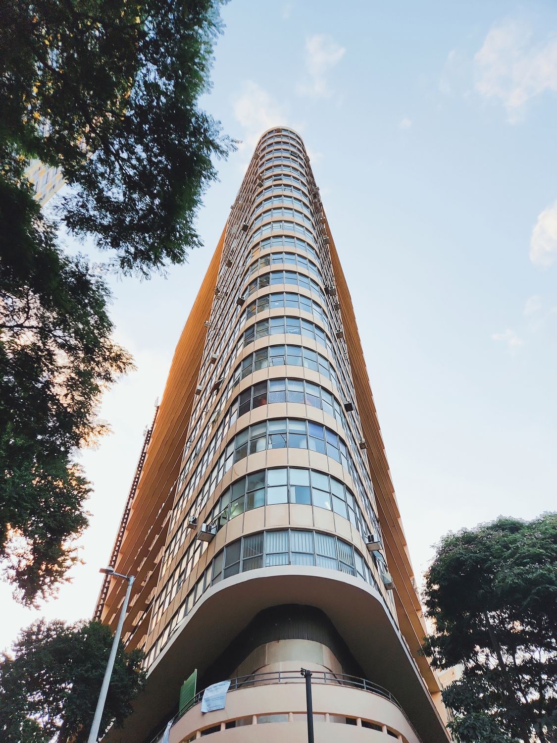 Rotationg Triangular High Rise Modern Triangle-Shaped High-Rise Building · Free Stock Photo