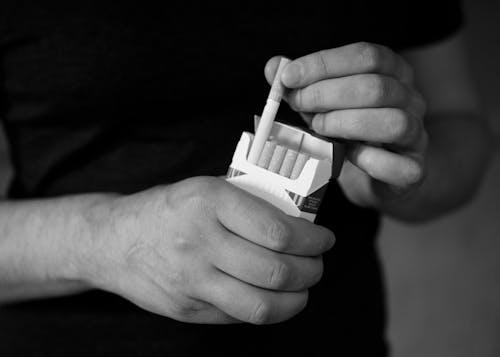 Kostnadsfri bild av cigaretter, gråskale, händer
