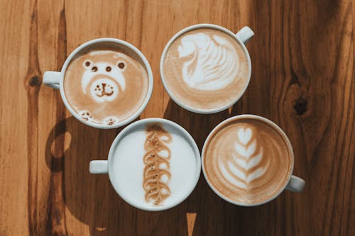 Free Top View of Cups of Coffee with Latte Art  Stock Photo