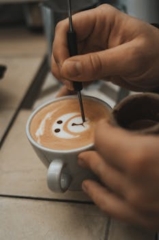 A close-up of a barista crafting intricate latte art in a café setting.