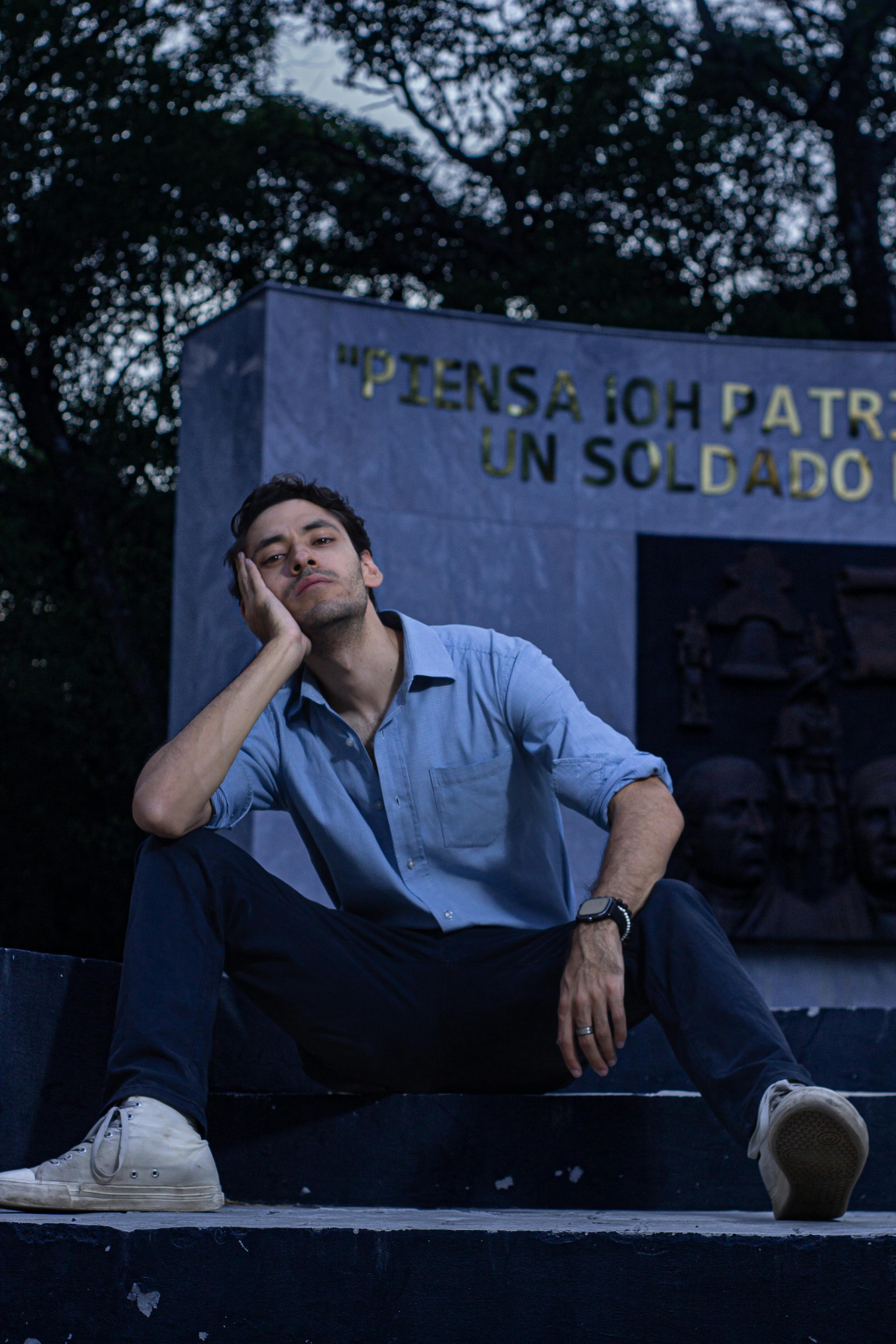 Fashionable man posing on stairs at dusk in a park, Ciudad de México.