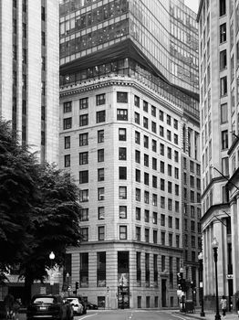 Monochrome image of downtown with tall office buildings and urban architecture.