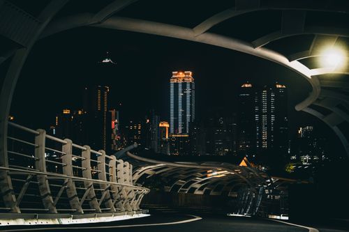 Free Illuminated Star-Of-Cianjhen Bridge in Kaohsiung with city skyline at night. Stock Photo