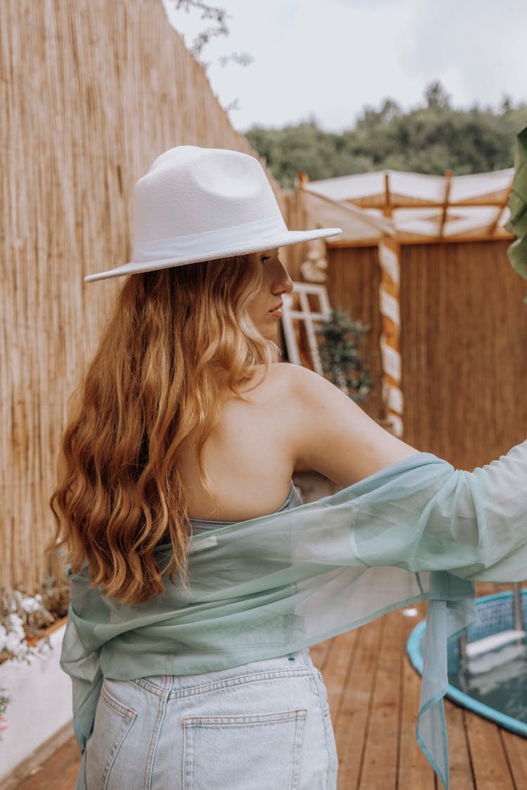 Photo Of A Blond Woman Wearing A Summer Hat And Delicate Blouse