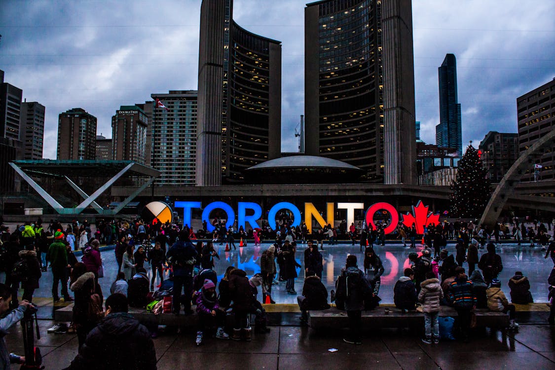 Free People Gathered in Front of Toronto Freestanding Signage Stock Photo