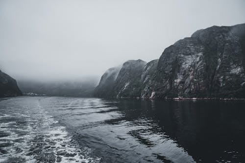 Cliffs by Lake on Foggy Day