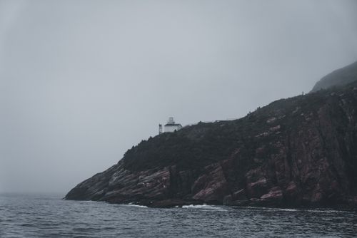 Rocky headland in fog, photo by Erik Mclean on Pexels