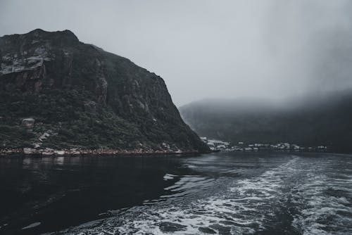 Mountain by Lake on Foggy Day