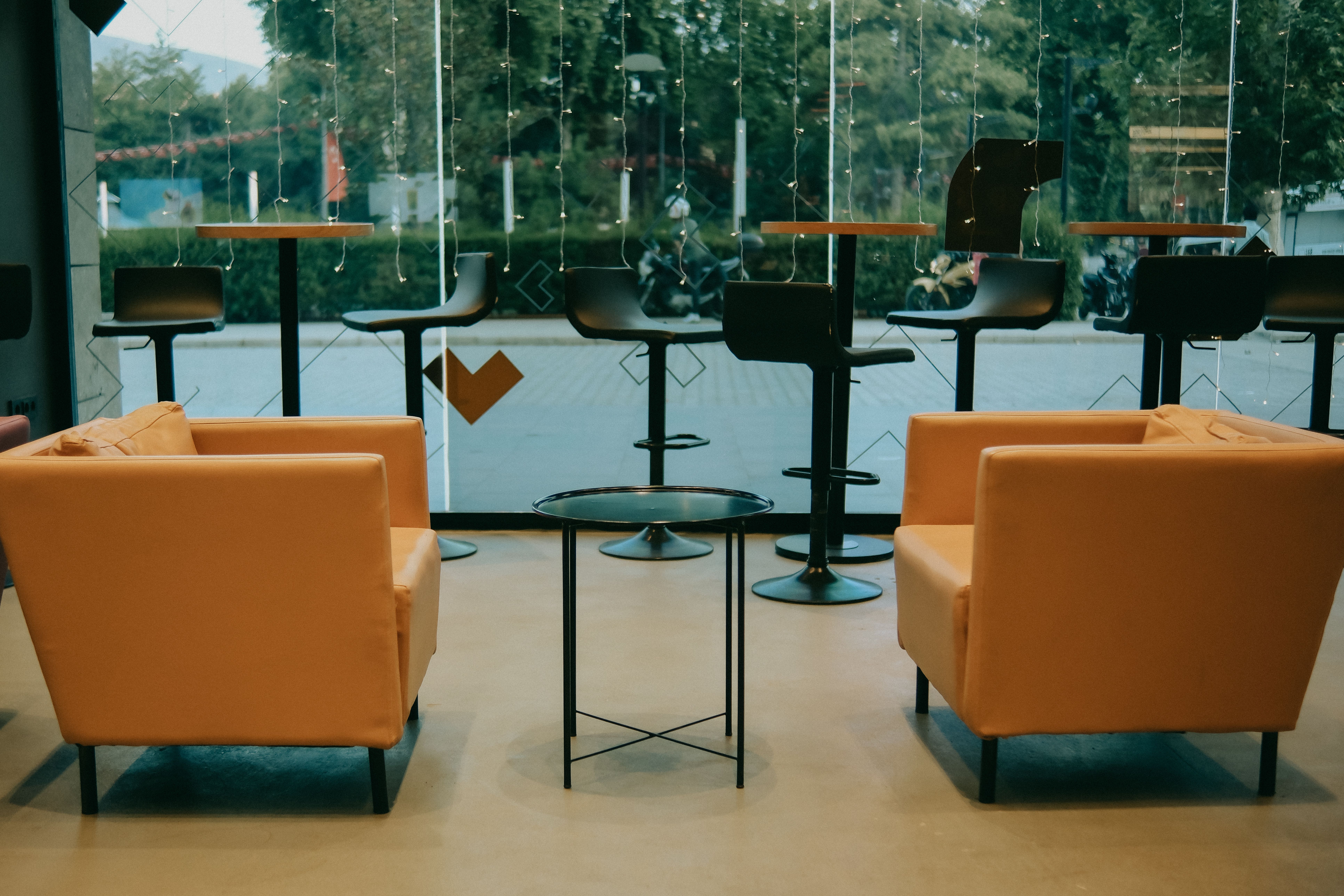 Parent lounge inside a Sinsa kids cafe with armchairs and specialty coffee bar
