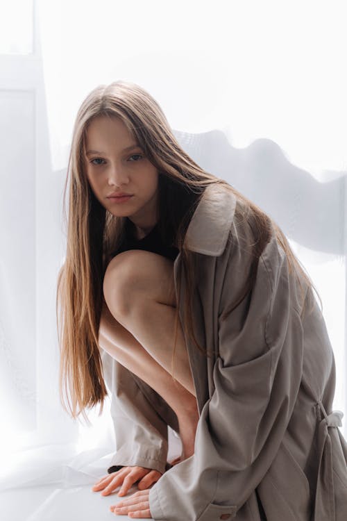 Young Girl Posing in a Trench Coat 