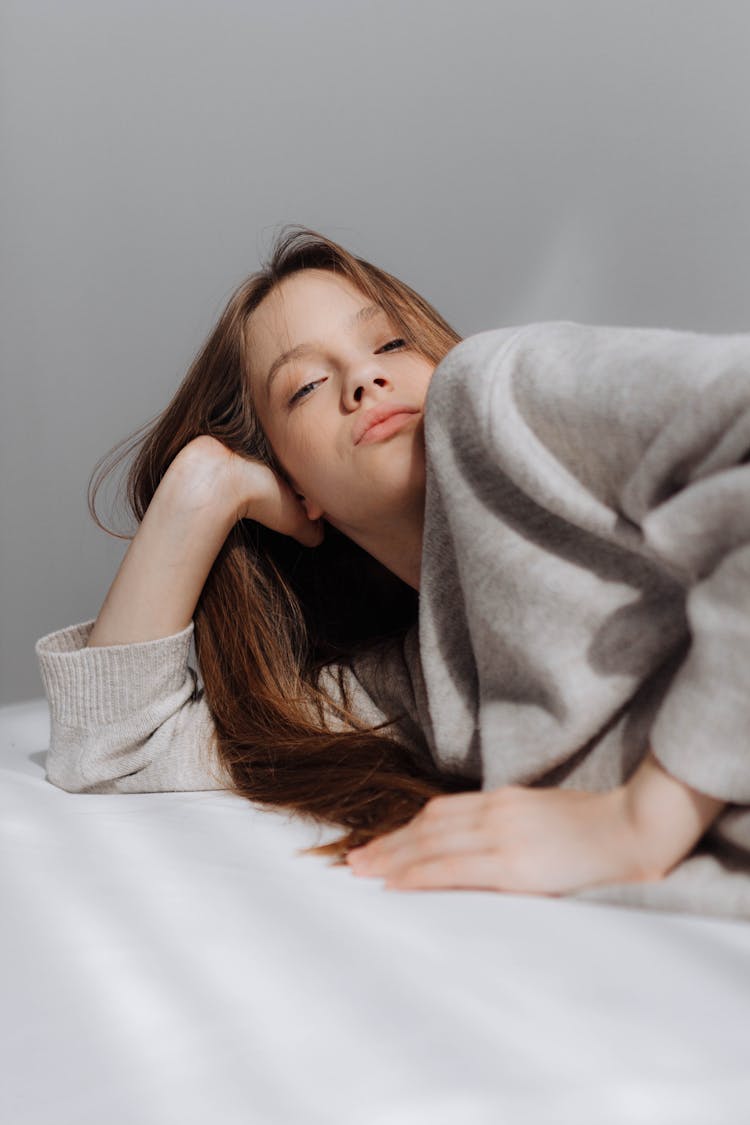 A Girl Lying On A Mattress