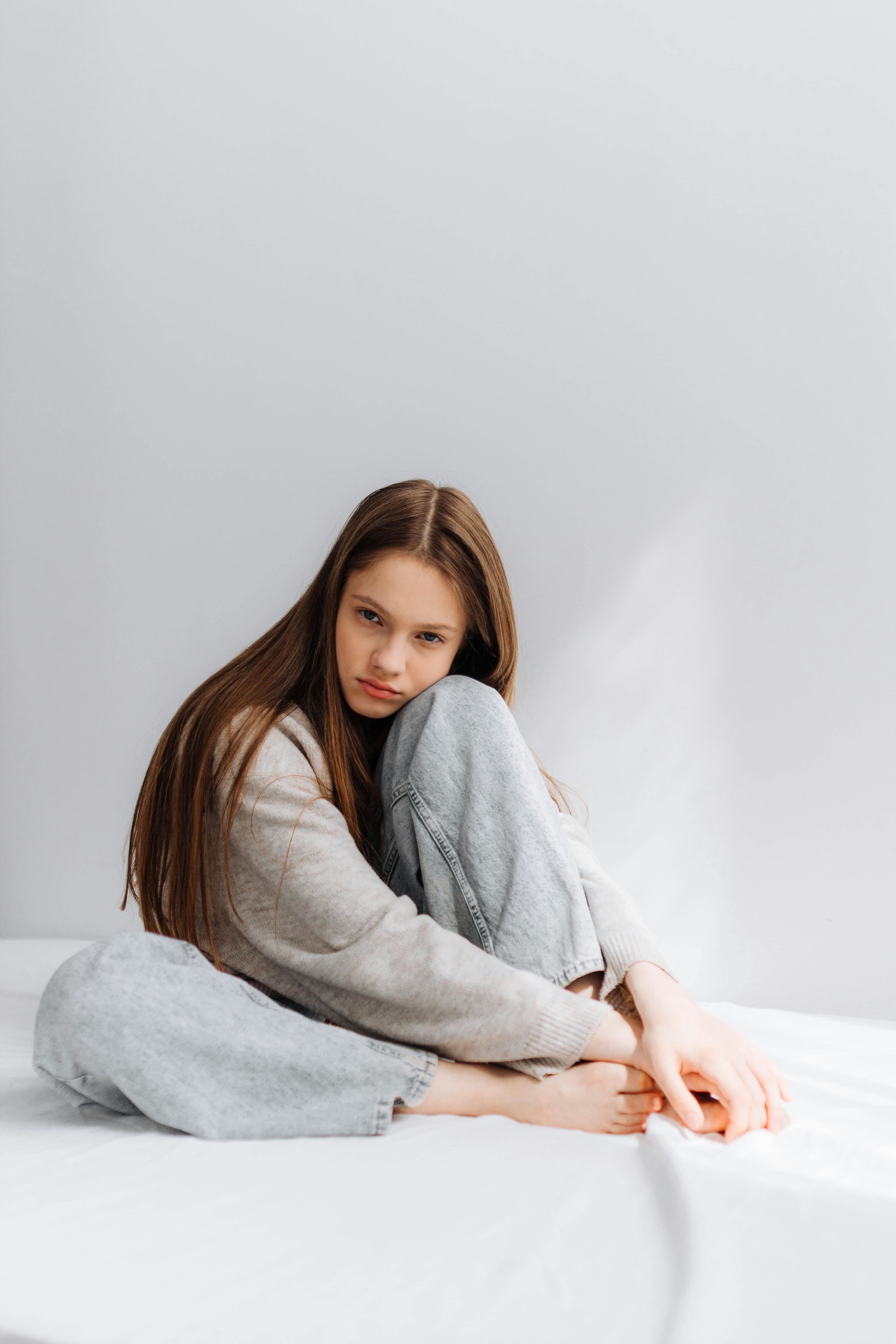 Sitting Woman Holding her Foot · Free Stock Photo