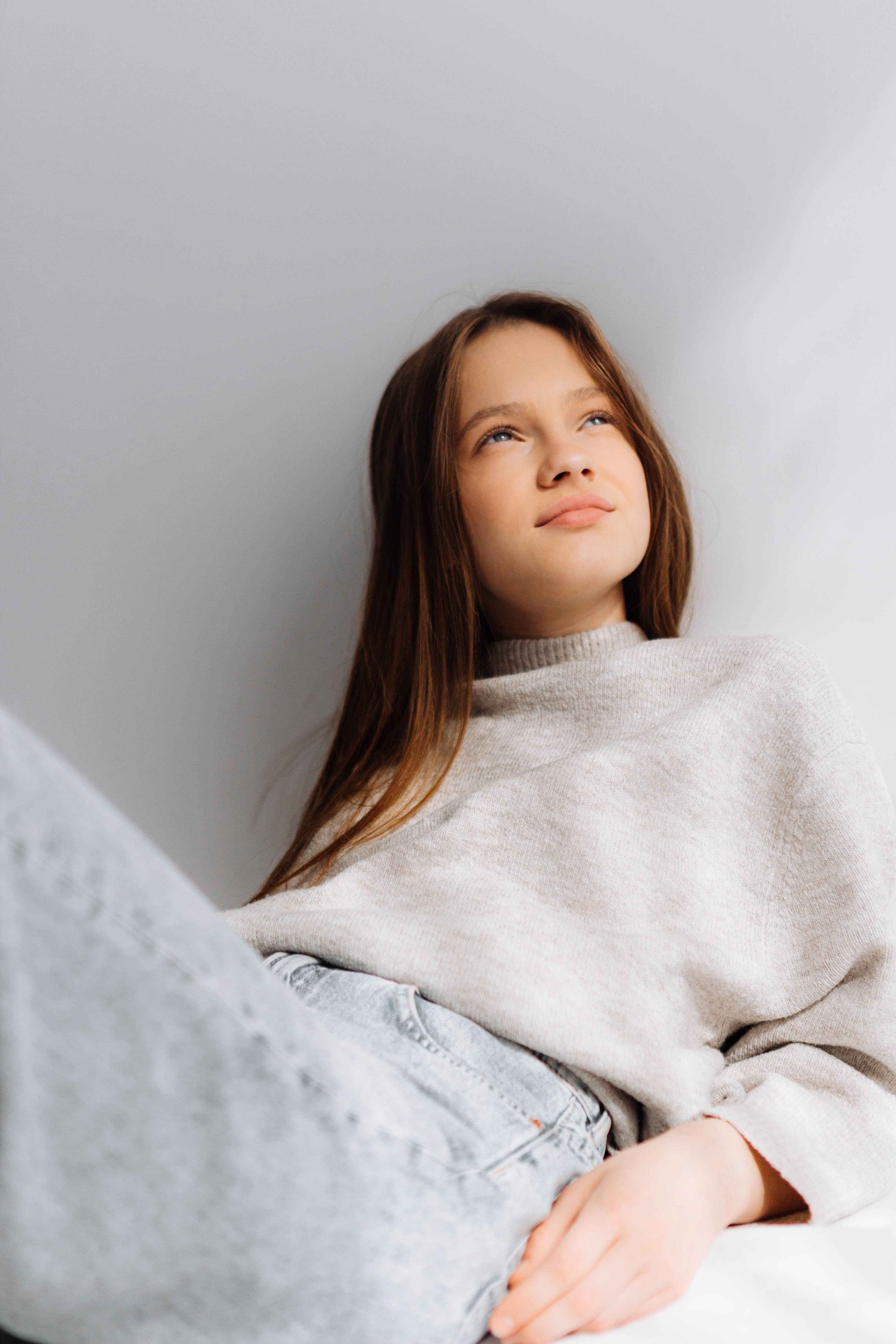 Woman in White Long Sleeve Shirt Lying on Bed · Free Stock Photo