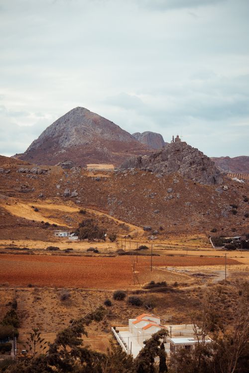 Free Beautiful rural landscape with arid hills and open fields under a cloudy sky. Stock Photo