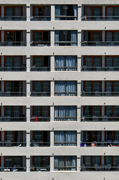 Close-up of a modern apartment building facade with multiple balconies showing urban living.