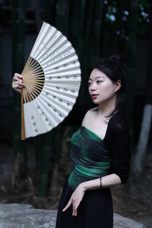 Woman Holding a Traditional Fan