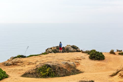 Person Standing Near Rocks