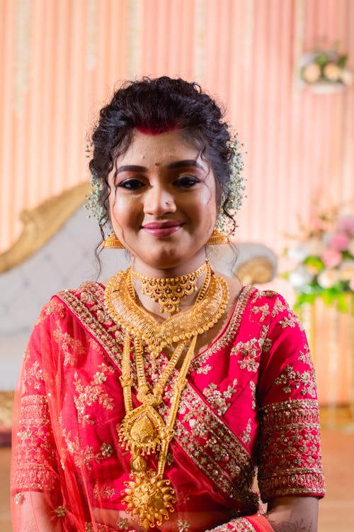 Smiling Bride in Traditional Clothing and with Golden Jewelry