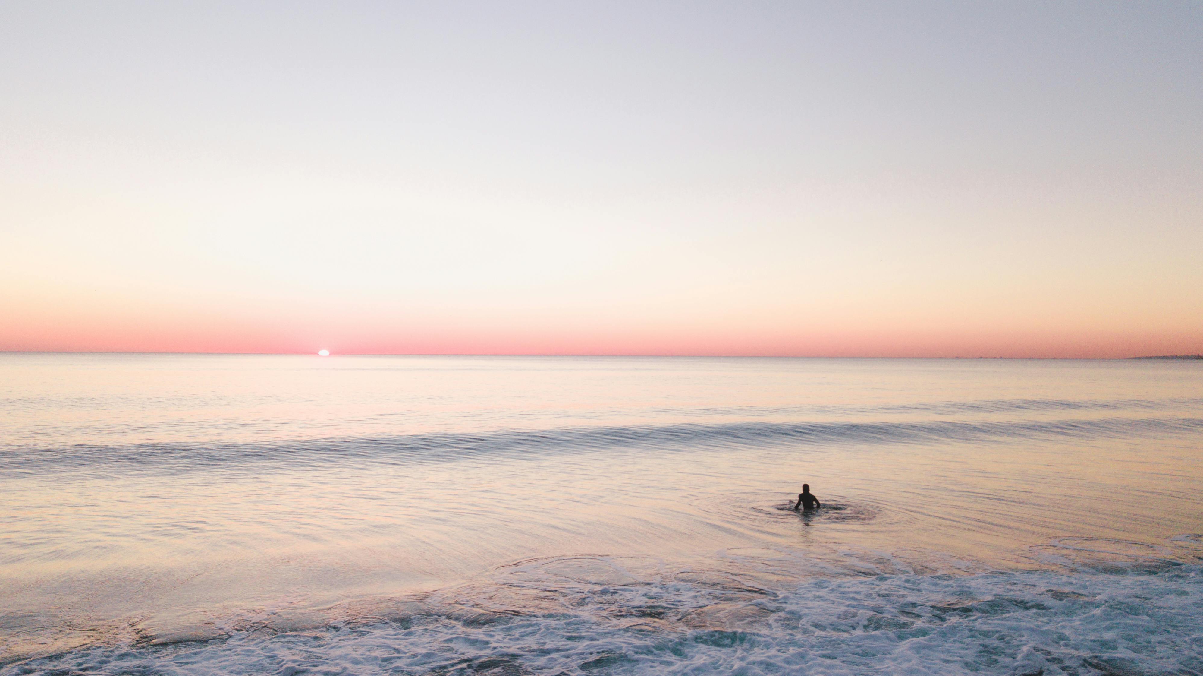 Person Swimming Alone In The Sea