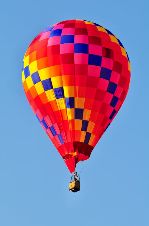 A colorful hot air balloon flying in the sky