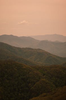 Breathtaking view of rolling mountains under a tranquil twilight sky.