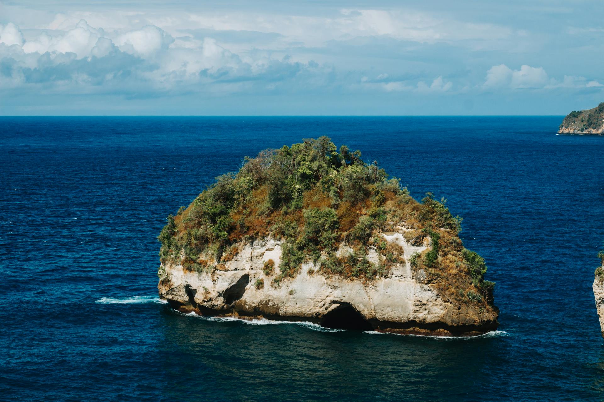 Beautiful small island surrounded by deep blue ocean water, perfect for travel inspiration.