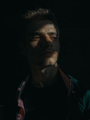 Dramatic portrait with shadows across the face — photo by Yasser Amin on Pexels