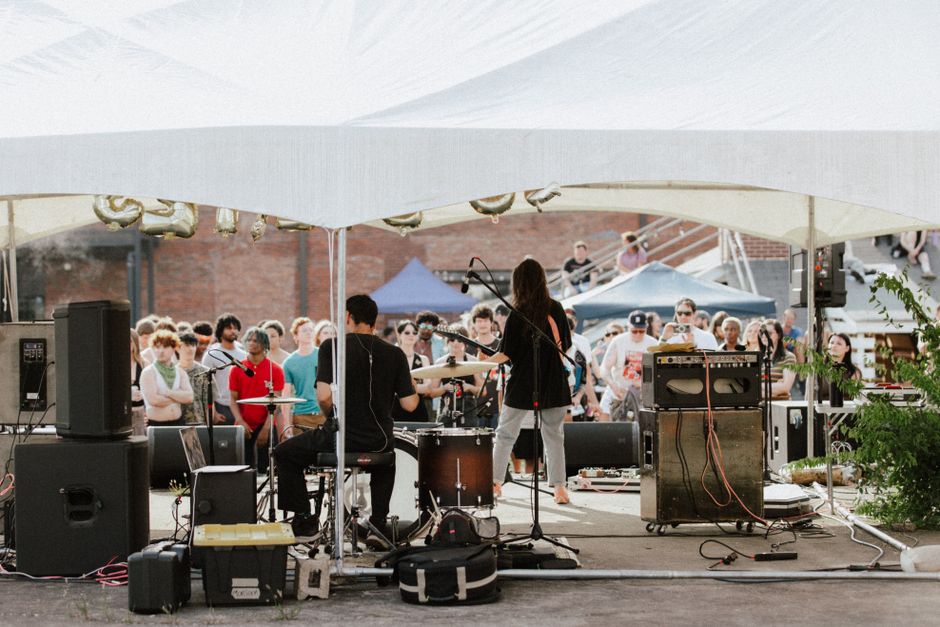 Live outdoor band performance under a tent at a Nashville event requiring amplified sound approval