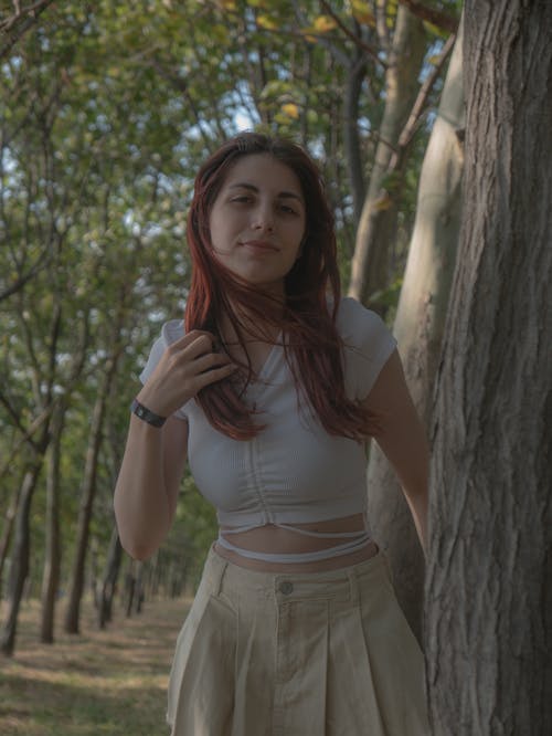 Model in White Crop Top and Beige Mini Skirt in the Park