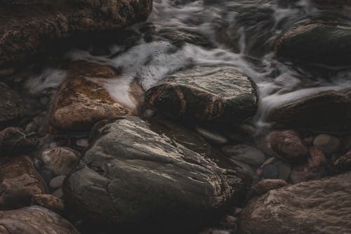 Close up of Stream Water Flowing over Stones