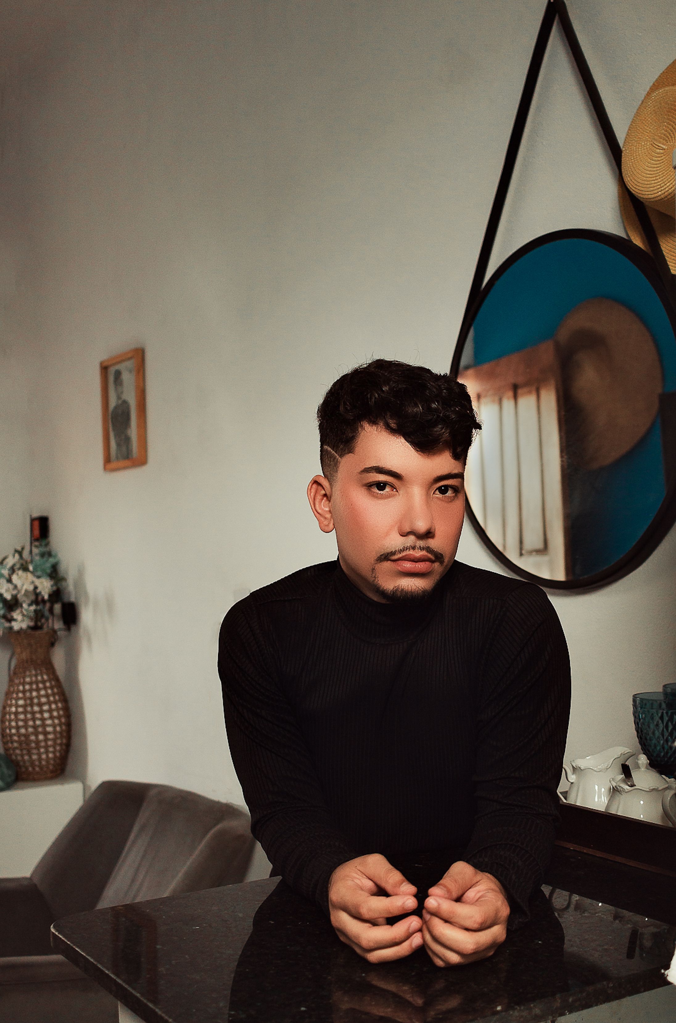 Stylish portrait of a man with a mustache in a contemporary São Luís home setting.