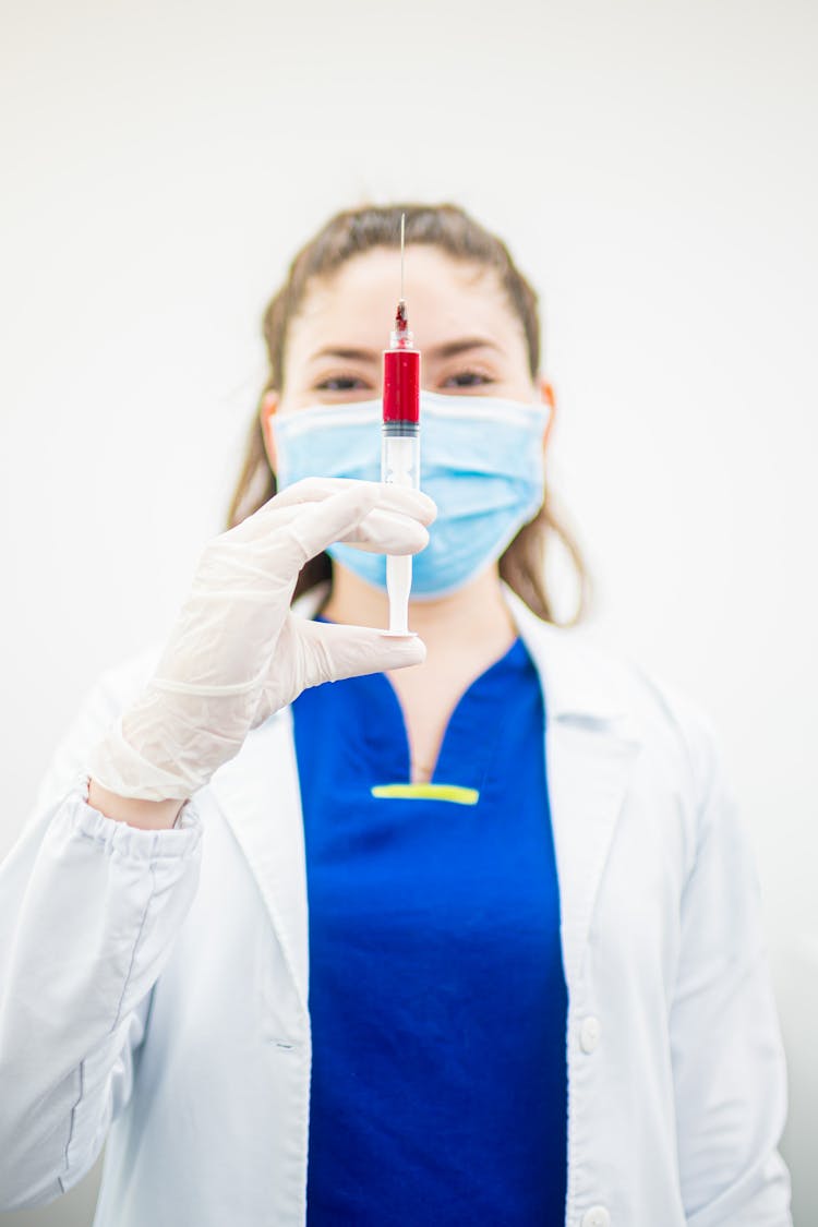 Nurse Holding Syringe With Blood Sample