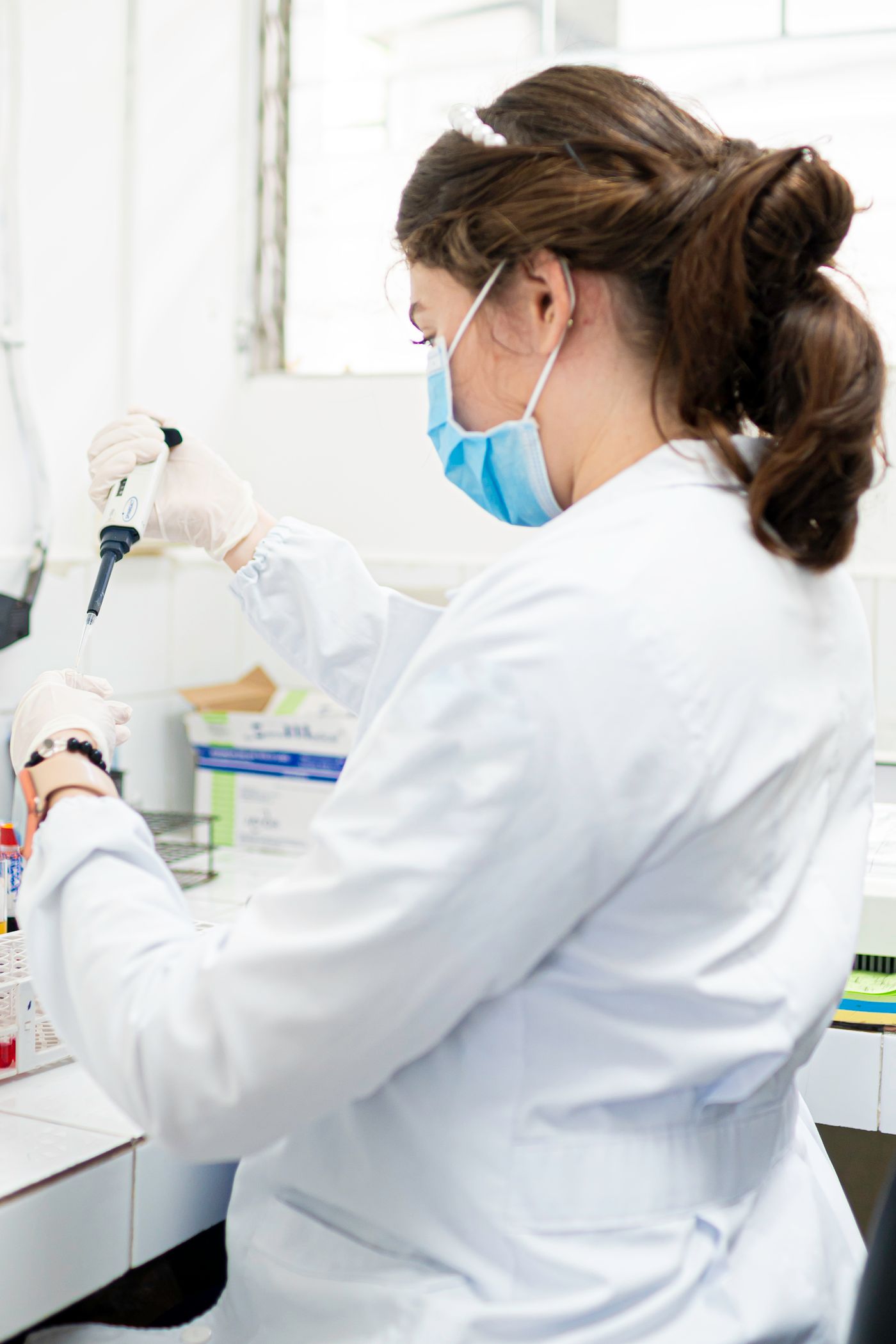 Medical laboratory scientist processing a blood sample for ovarian reserve testing