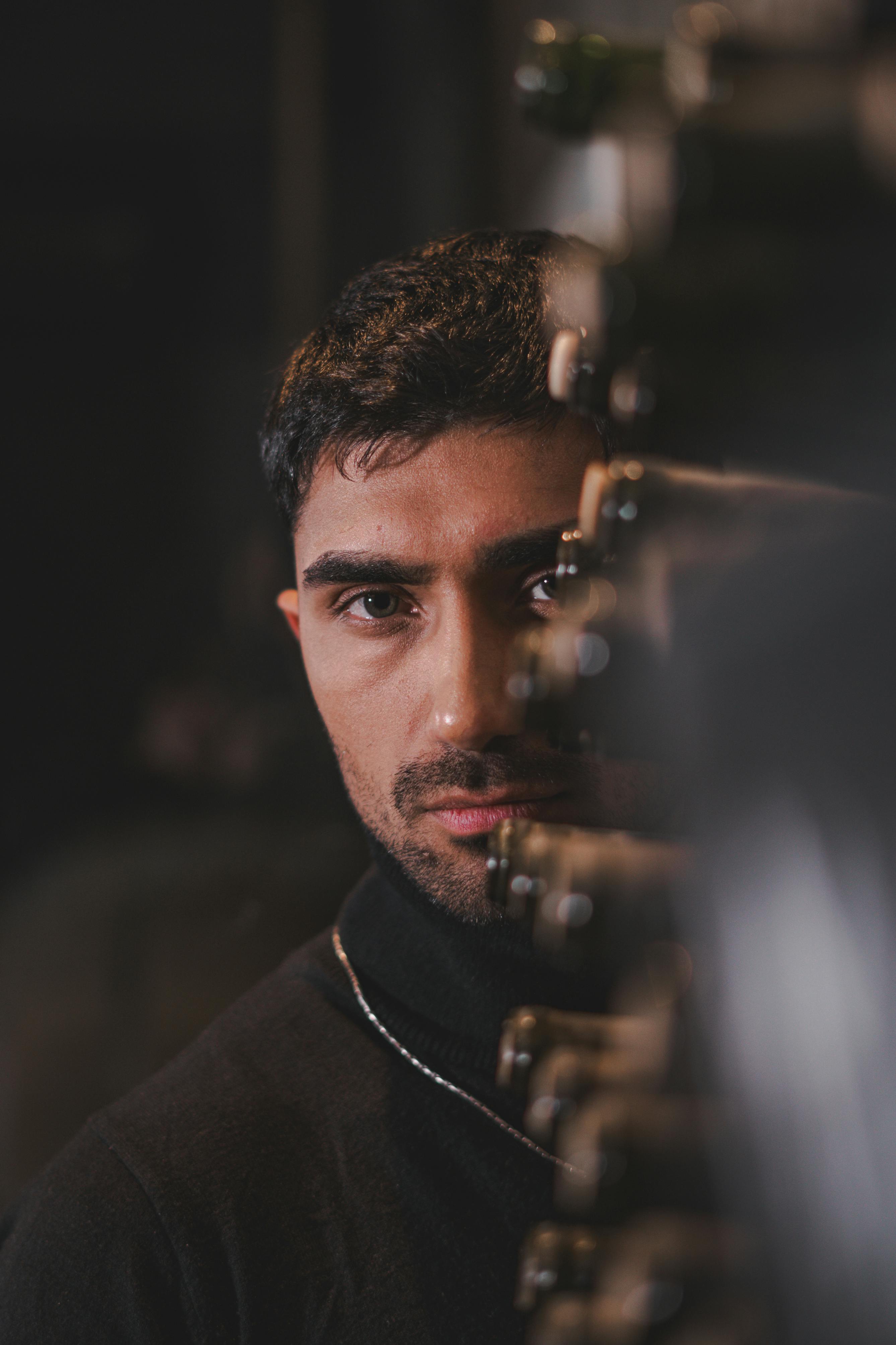 Man behind Case with Wine Bottles