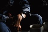 Wristwatch under a denim sleeve — photo by Dương Nhân on Pexels