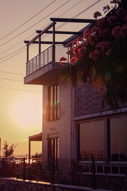 Free Contemporary house with floral terrace and sunset view, showcasing modern architecture and nature. Stock Photo
