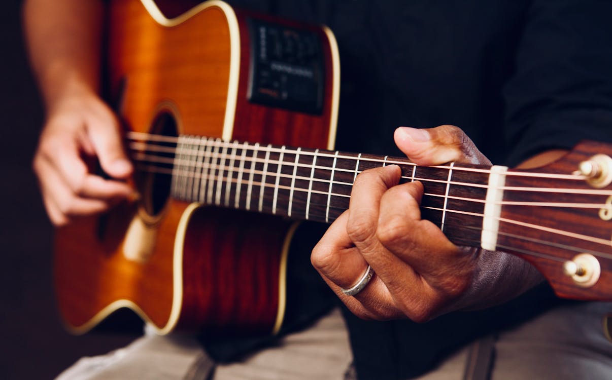 Free Photo of Person Playing Acoustic Guitar Stock Photo