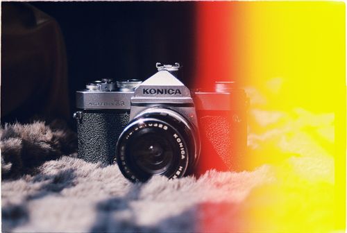 Free Close-up of a vintage Konica AutoReflex T3 camera with a striking light leak effect. Stock Photo