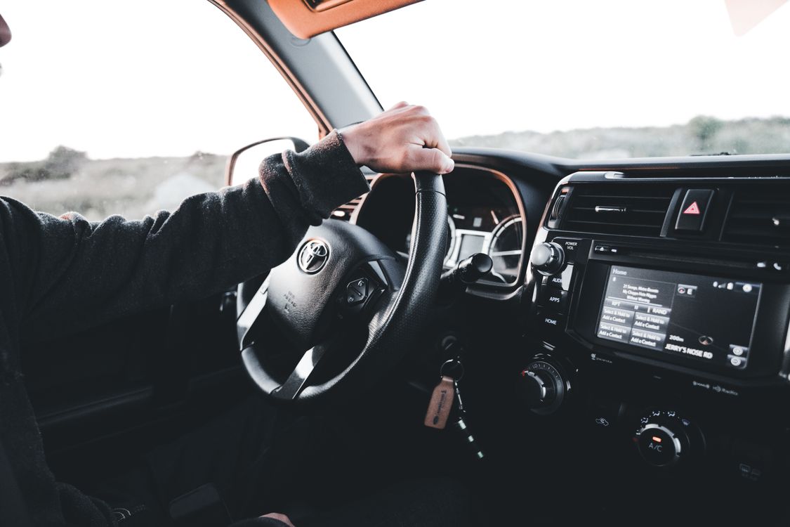 Hand Driving Toyota Car · Free Stock Photo