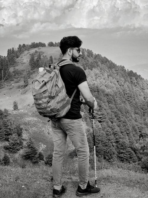 Bearded Man with Backpack Standing on Hill