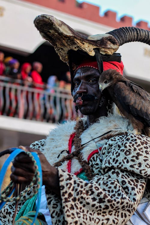 Man in Traditional Clothing and with Hawk on Parade
