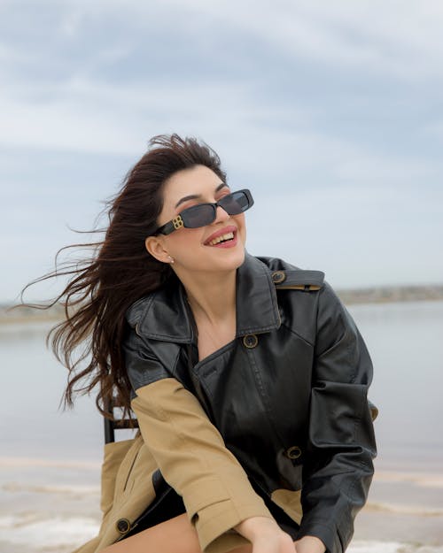 Smiling Woman in Black Jacket and Sunglasses