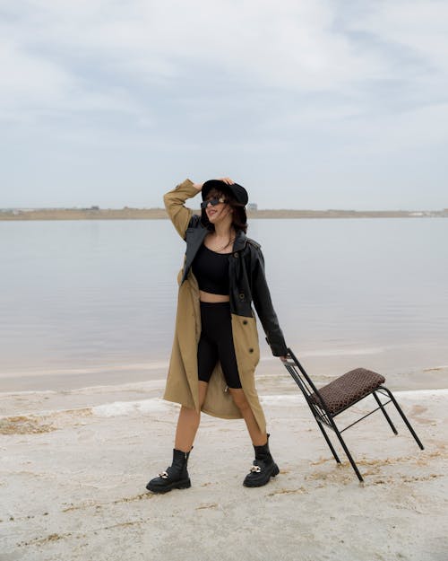 Free Woman Dragging Chair on Beach Stock Photo