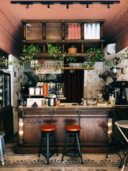 Warm vintage-style bar interior with stools and coffee setup, perfect for a cozy atmosphere.