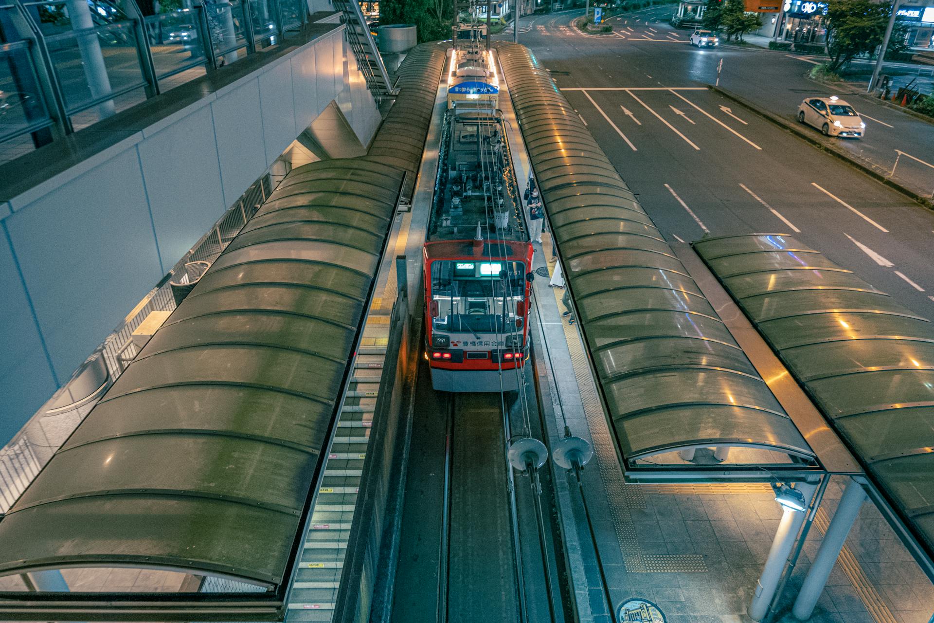 Aerial view showcasing the modern architecture of Toyohashi train station in Japan at night.