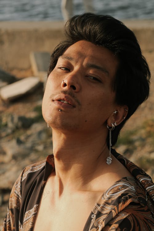 Man with Earring and Black Hair at Beach