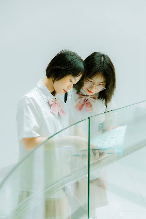 Two Girls Reading Book