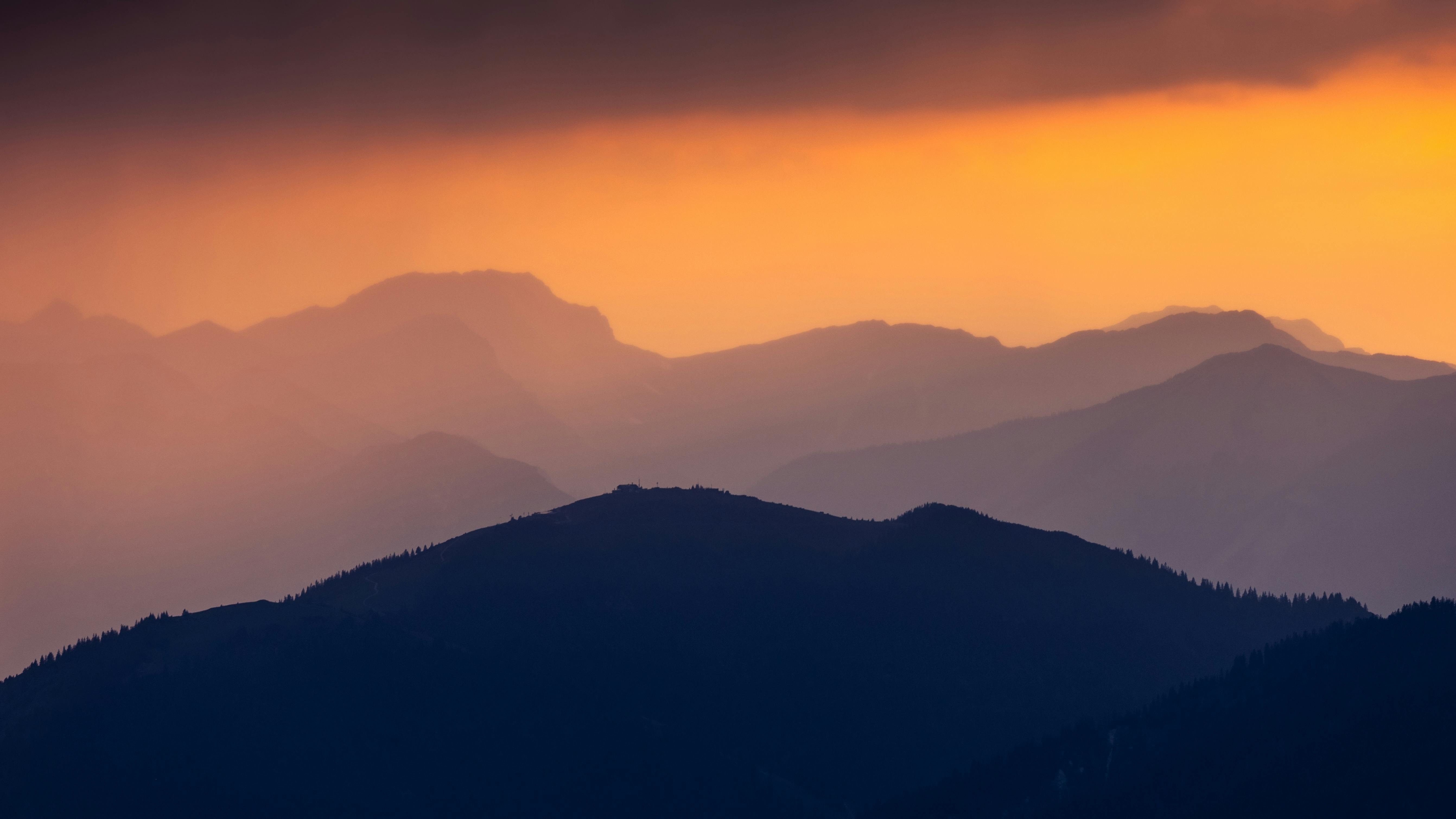 Prescription Goggle Inserts - Serene sunset view over the layered Bavarian Alps with a mystical orange glow, creating a tranquil and magical atmosphere.