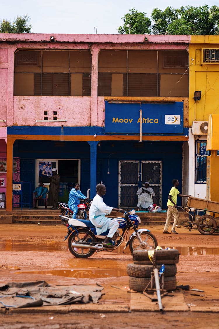 Man Riding On Motorcycle On Muddy Street